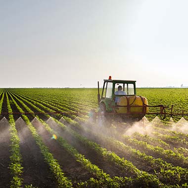A farm tractor fertilises crops introducing nitrogen in the form of ammonia.